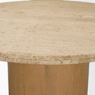 Detailed view of the Romina table’s sandblasted travertine surface and substantial rounded edge