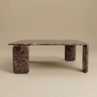 Marble coffee table with a red veined pattern on a beige background