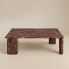 Front studio view of the Rosso Forma coffee table featuring deep red Rosso Levanto marble and pill-shaped legs.