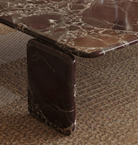 Close-up macro detail of the Rosso Forma coffee table showing the seamless bullnose edge and pill-leg marble construction.
