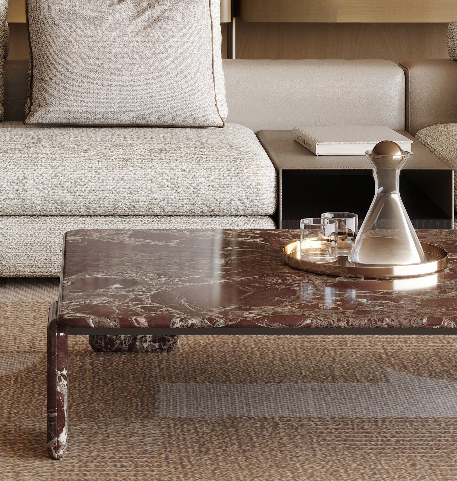 The Rosso Forma coffee table styled in a luxury living room with a gold tray and crystal decanter on a textured brown rug.