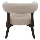 Rear studio view of the Rowan accent chair showcasing the continuous curve of the backrest and architectural dark wood base.