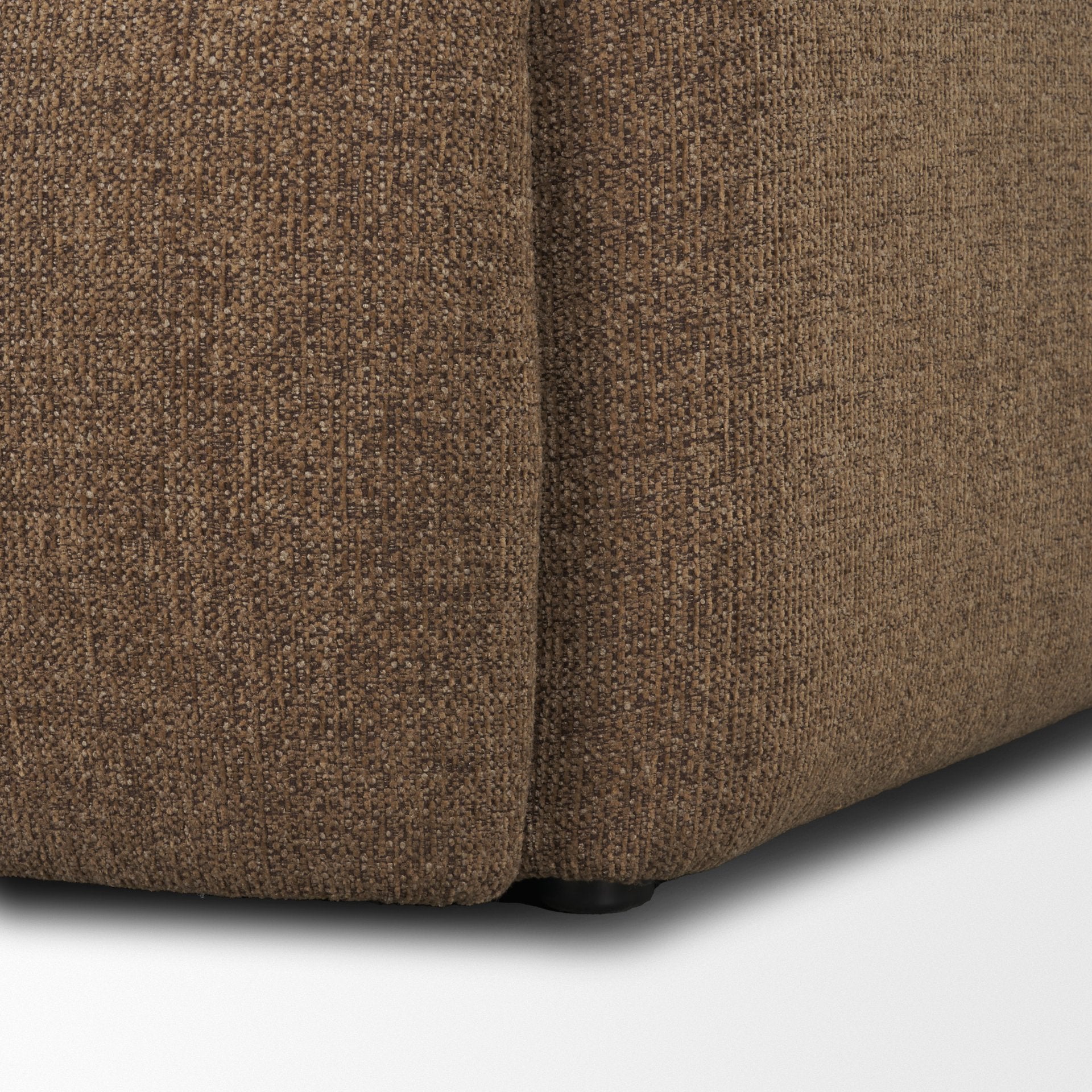 Close up of the bottom corner of the Rowan chair showing the durable mocha upholstery.