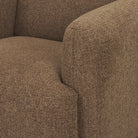 Detail shot of the plush seat cushion and rounded armrest on the Rowan mocha accent chair.