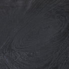Macro detail of the Ryn side table showing the rich wood grain texture visible through the matte black finish.