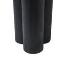 Detail view of the base of the black Ryn side table, showing the thick cylindrical legs and sturdy construction.