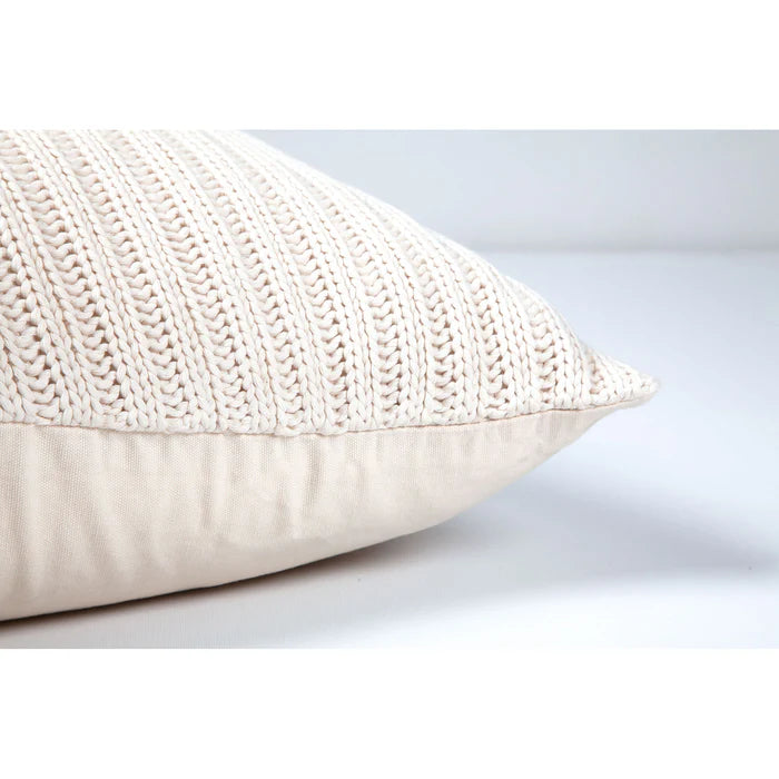 Side profile view of the plush Sadie knit pillow showcasing its chunky textured front and smooth neutral backing.