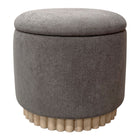 Gray round ottoman with a textured surface and wooden legs on a white background