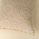 Textured fabric with intricate patterns on a beige background