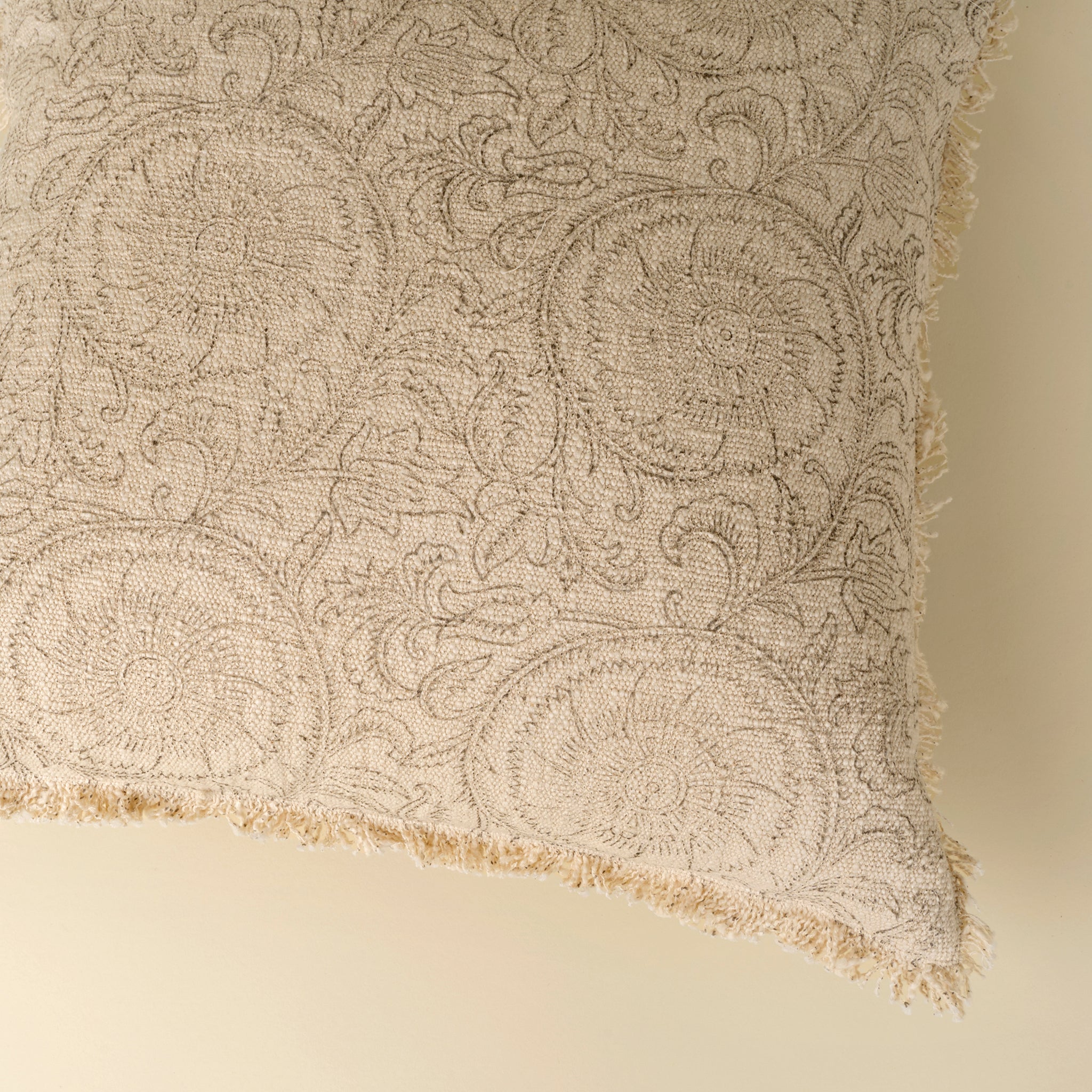 Textured fabric with intricate patterns on a beige background