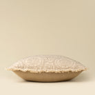 Decorative pillow with lace trim on a beige background