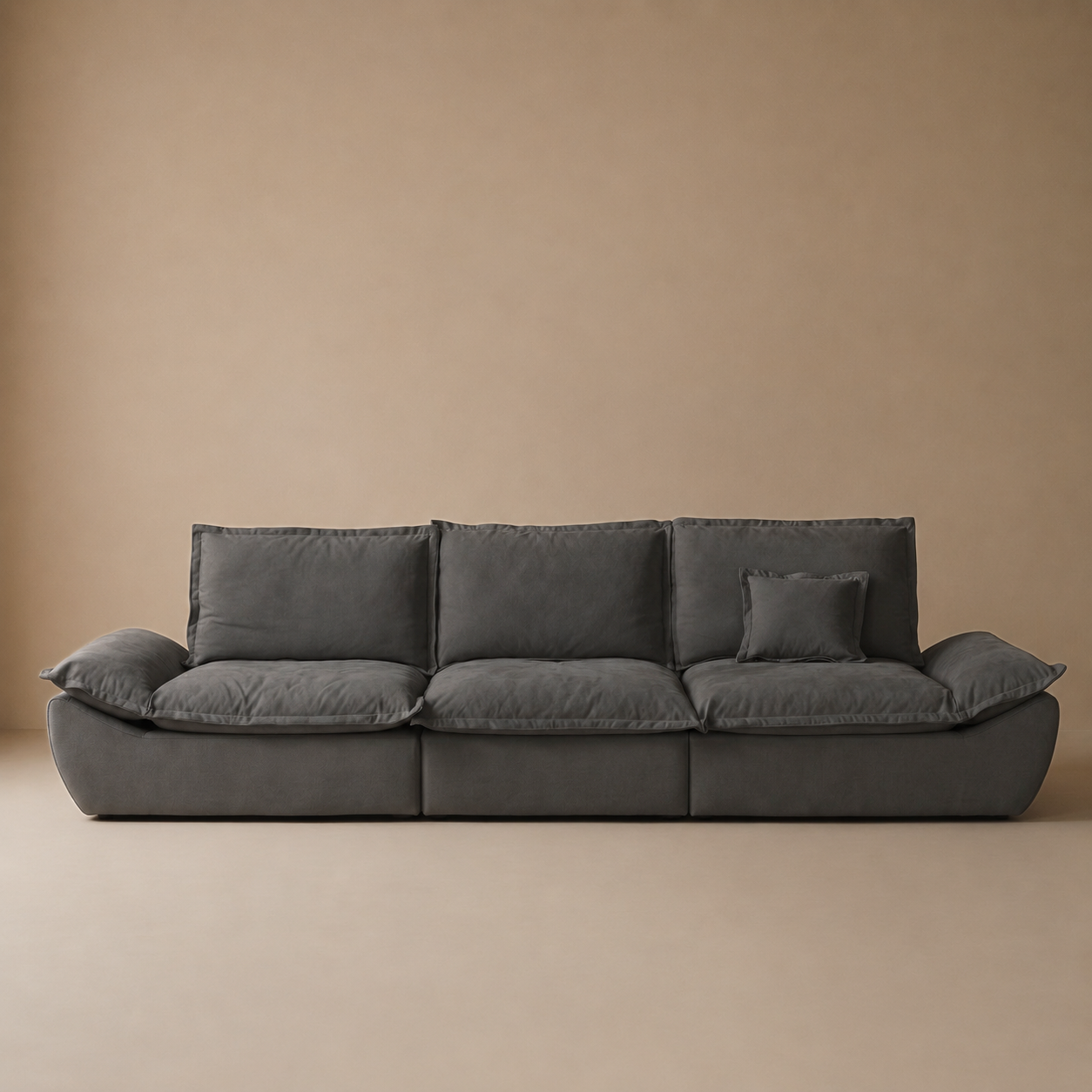 Full front studio view of the Ultra Comfort sailing-shaped sofa in charcoal grey featuring flange-edged cushions.