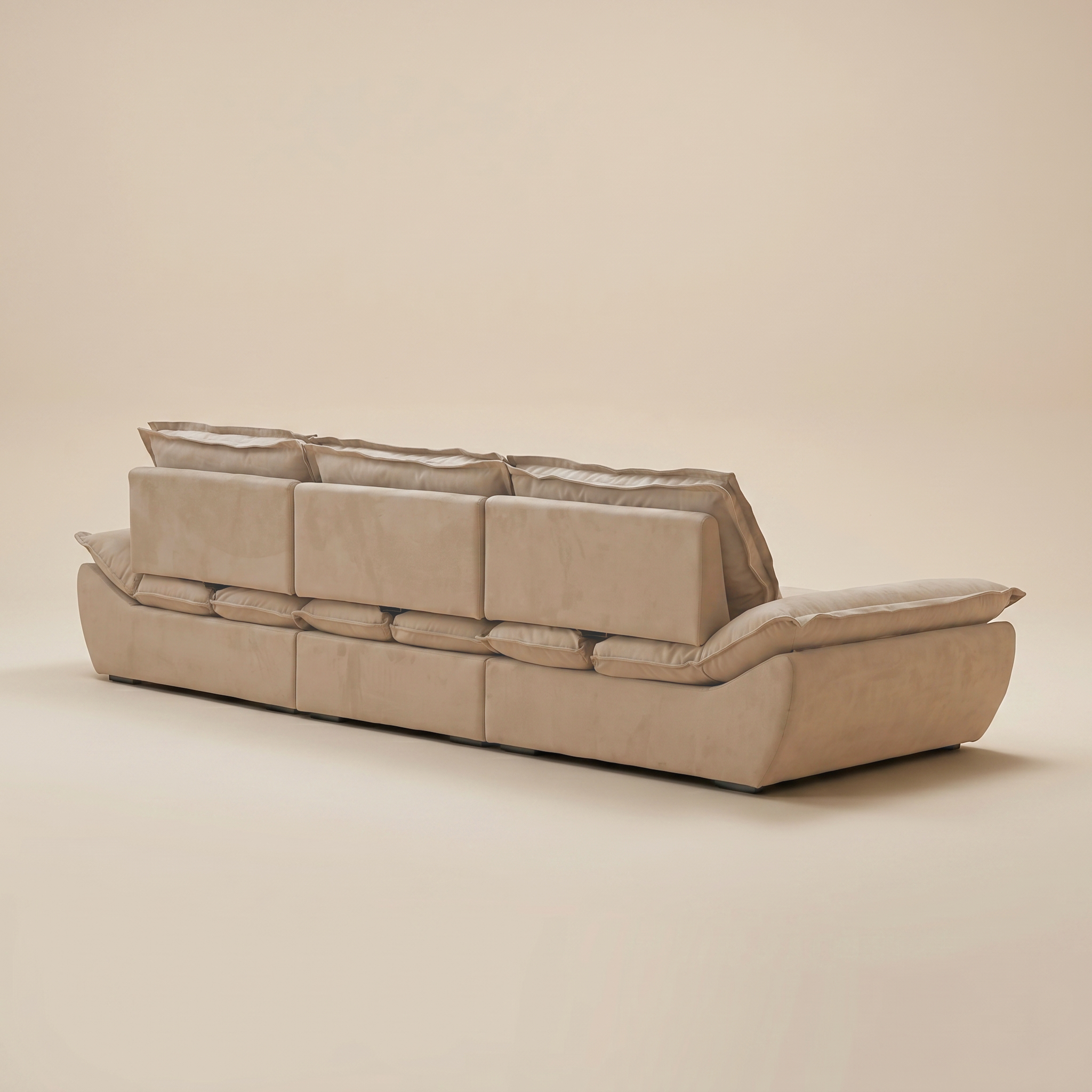 Rear studio view of the sailing-shaped sofa showcasing the modular base and adjustable backrest supports.