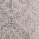 Close-up of beige floral lace fabric texture