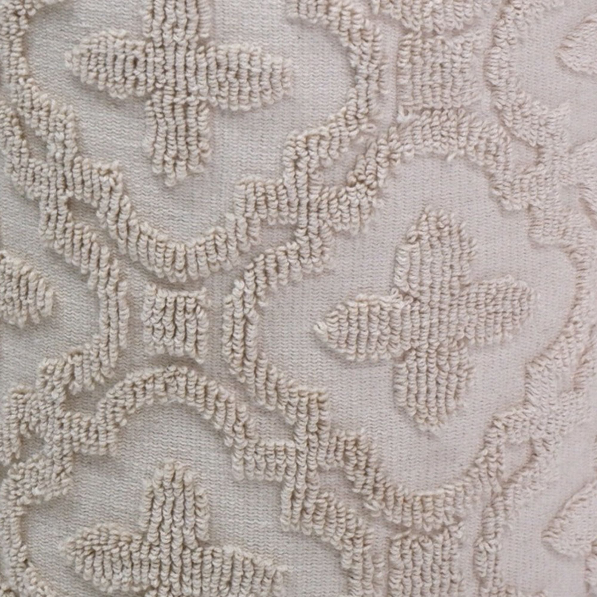 Close-up of beige floral lace fabric texture