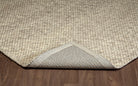 Folded corner of the ivory Silas hand-woven wool rug showing its thick loops and durable woven backing.
