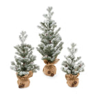 Small, medium, and large snow-flocked tabletop trees with burlap bases and bells