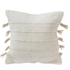 Textured pillow with tassels on a white background