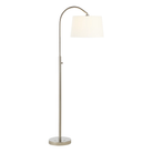 Solenne Arc Floor Lamp in polished nickel illuminated to show the warm glow through its off-white linen shade.