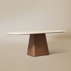 Angle view of the oval Sorella Dining Table in beige studio background