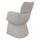 Rear angled view of the oatmeal Soren bouclé dining chair and curved upholstered back