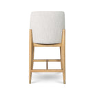 Rear view of the Sterling stool showcasing the clean lines of the blonde wood frame and the seamless taupe bouclé upholstery.