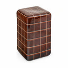 Tessera chestnut brown carved clay side table with a rounded rectangular grid design on a white background.