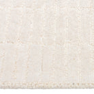 Close-up of the Tessera Hand-Tufted Wool Grid Rug in ivory showing its soft wool pile and subtle raised grid texture.