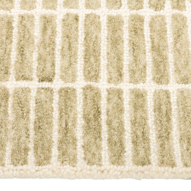 Close-up of the Tessera Hand-Tufted Wool Grid Rug in sage showing its soft wool pile and ivory grid lines.