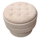 Beige fabric ottoman with tufted top on a white background