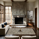 Modern living room with stone fireplace, white sofa, and wooden floor.