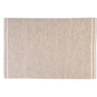 Full top-down view of the Theo hand-woven wool rug in a warm husk oatmeal color, showcasing its geometric woven pattern and banded ends