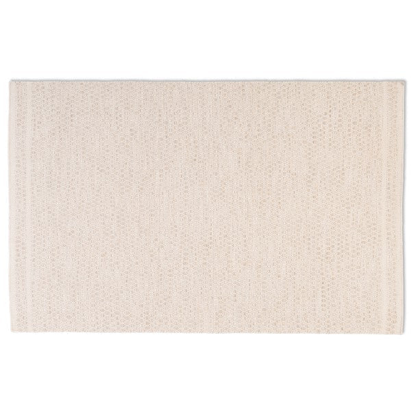 Full top-down view of the Theo hand-woven wool rug in ivory cream, featuring a chunky honeycomb basketweave texture and banded edges