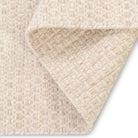 Folded corner of the ivory Theo hand-woven rug showing the identical front and back basketweave pattern typical of flatweave construction