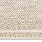 Macro view of the husk Theo rug's surface highlighting the intricate chunky basket weave texture woven from tonal oatmeal wool yarns.