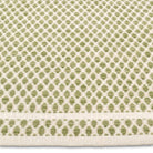 Detailed close-up of the chunky geometric honeycomb weave on the sage green and cream Theo hand-woven wool rug.