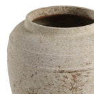 Close-up of a textured ceramic pot on a white background