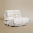 Angle view of the TOGO Lounger in matte white in studio background