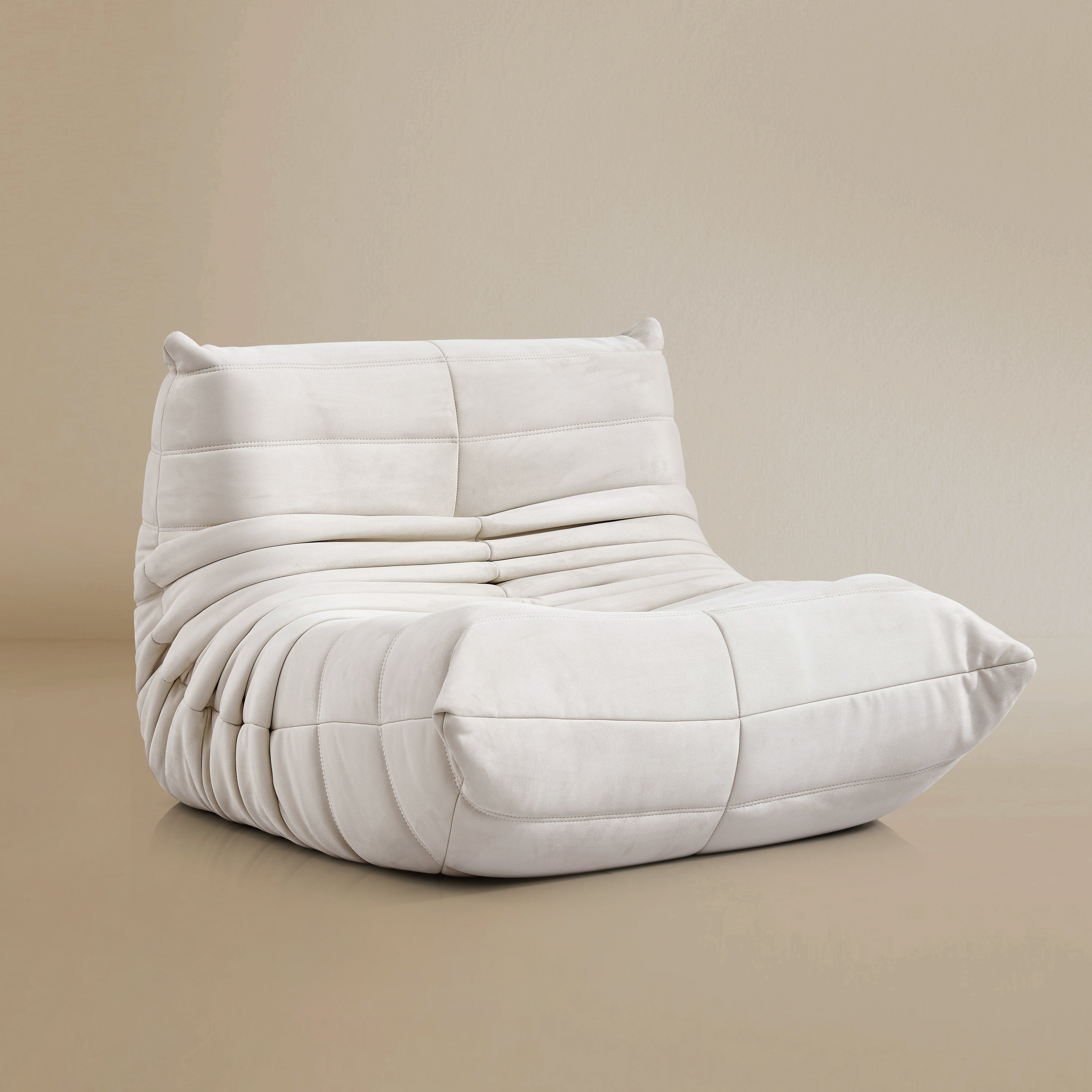 Angle view of the TOGO Lounger in matte white in studio background