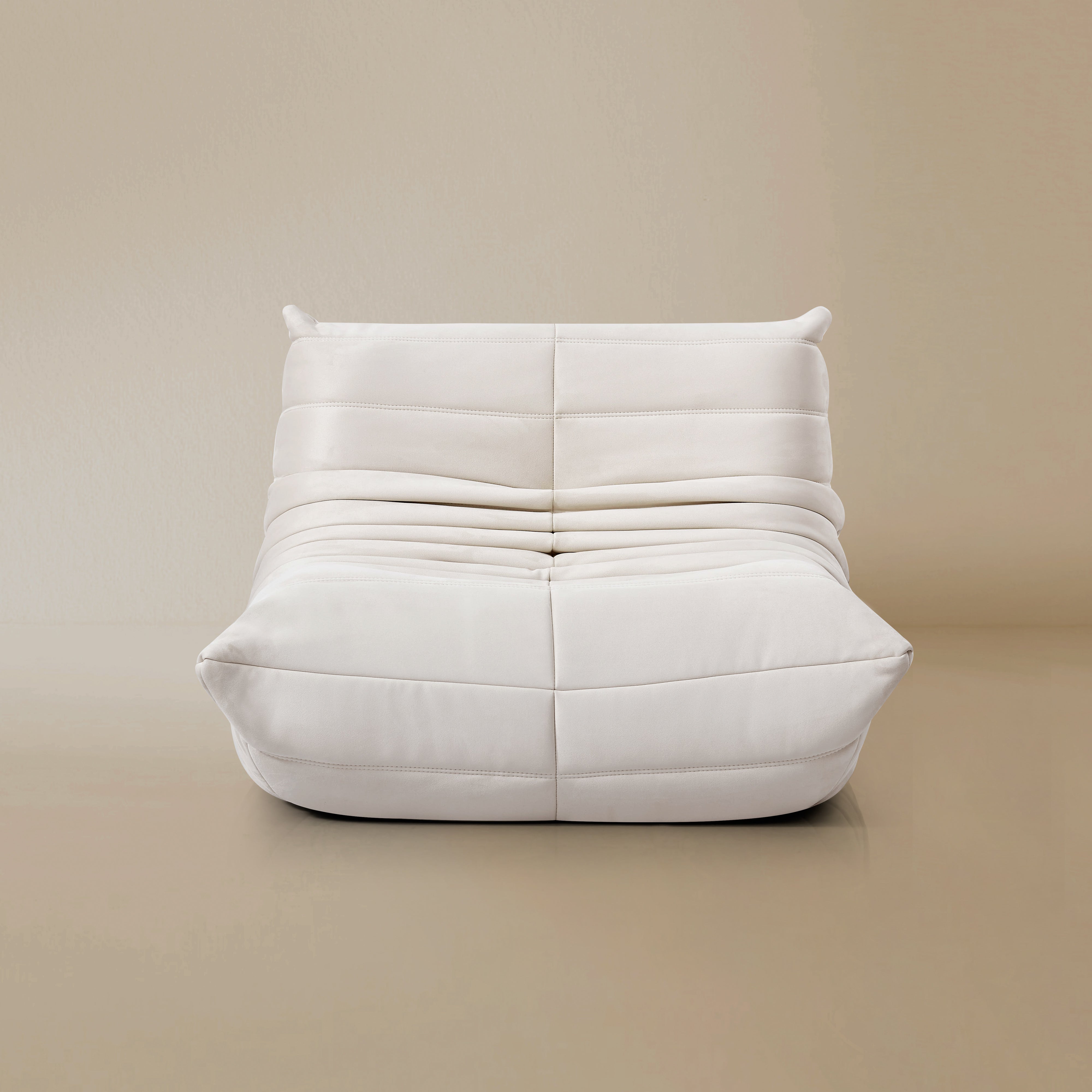 Front view of the TOGO Lounger in matte white in studio background