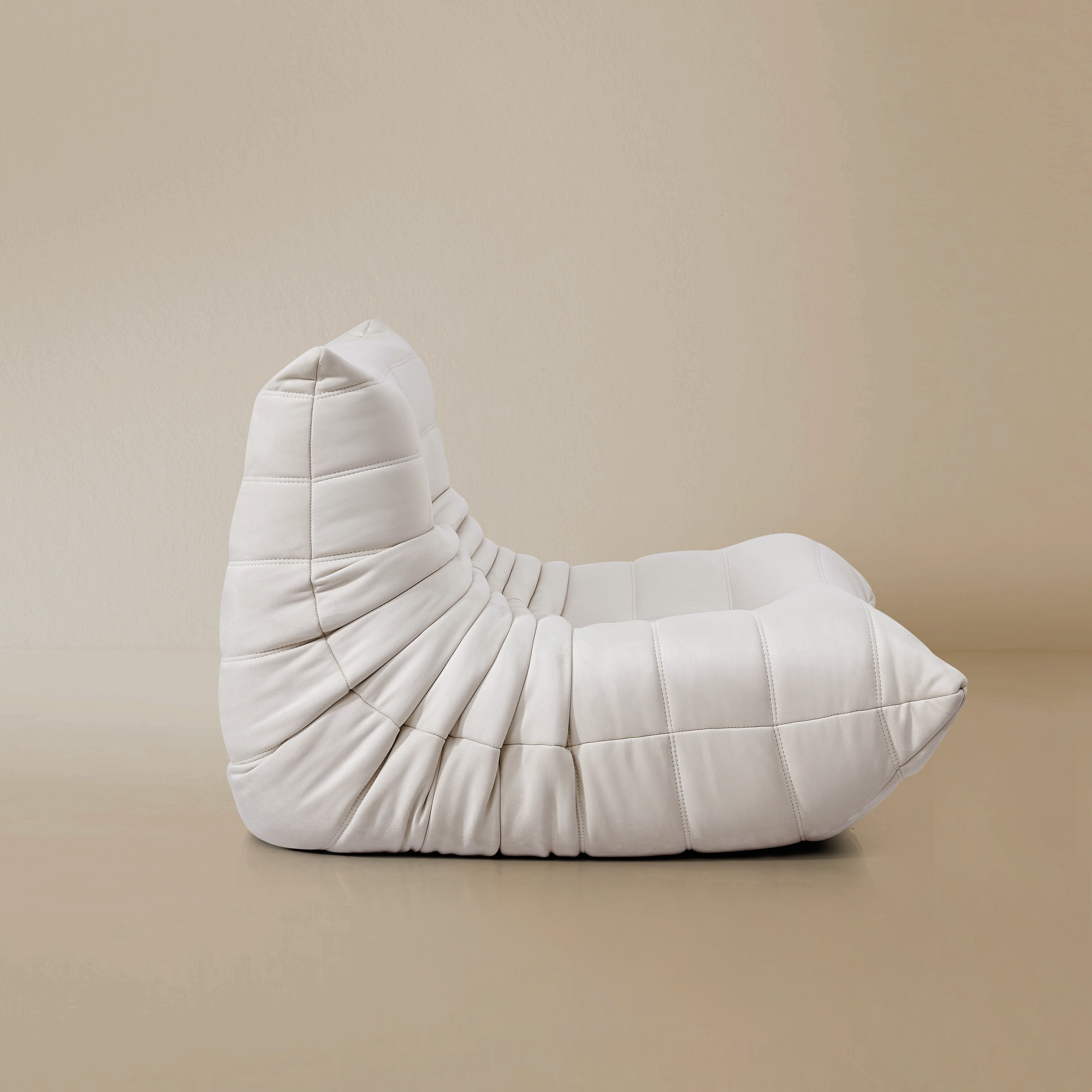 Side view of the TOGO Lounger in matte white in studio background