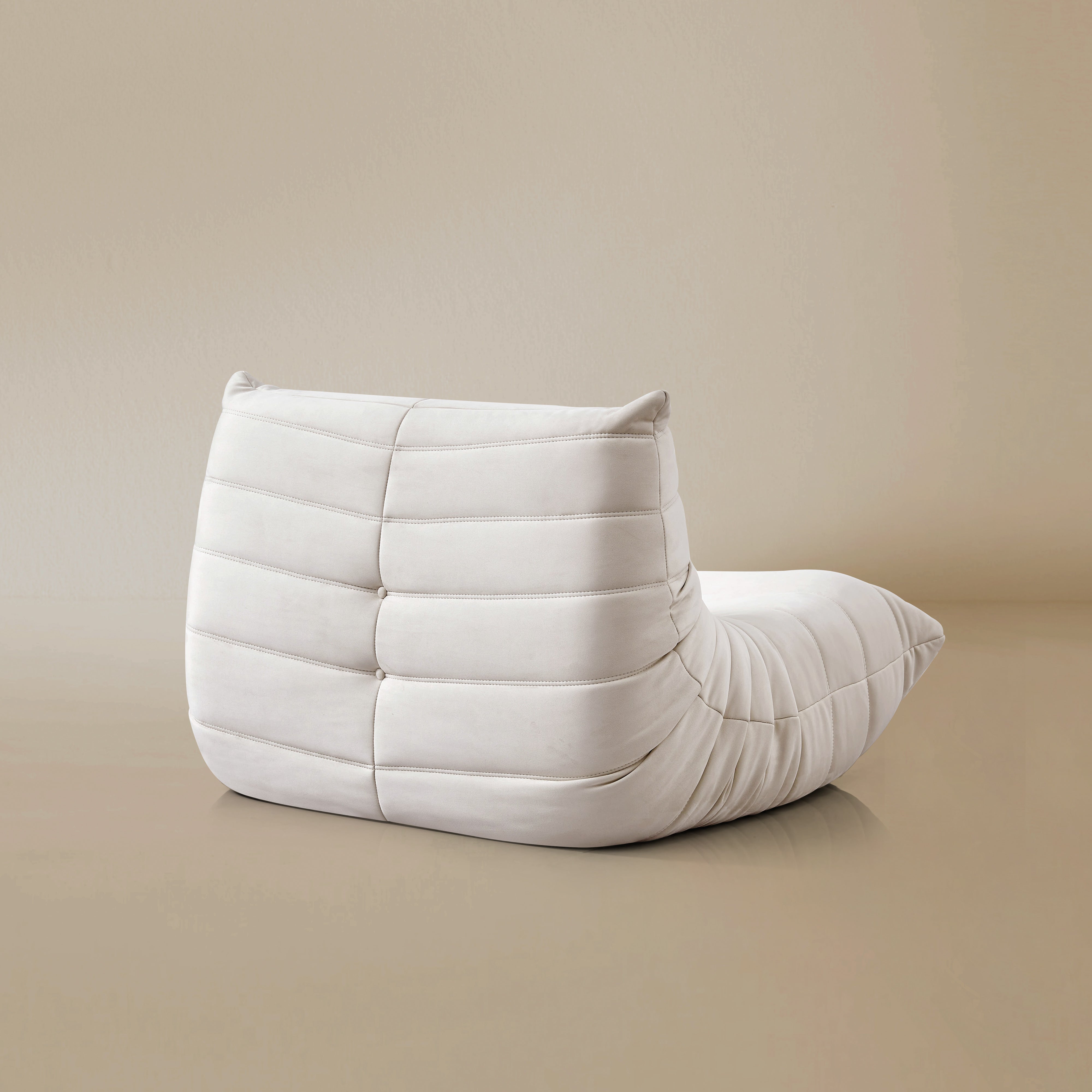 Back view of the TOGO Lounger in matte white in studio background