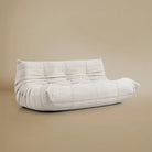 Angle view of the TOGO Three Seater Lounger in a light beige studio background
