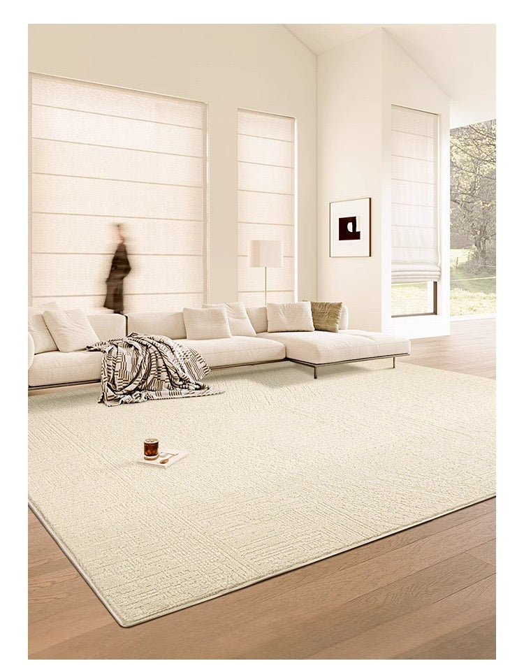 Angled view of the Tranquil Ivory Carpet in a modern living room with warm wood flooring