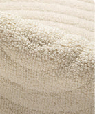 Folded detail of the Tranquil Ivory Carpet showing its plush cream textured pile