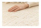 Close-up of the Tranquil Ivory Carpet showing the soft raised pattern under hand