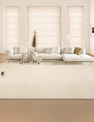 A large, plush, creamy beige area rug in a bright living room setting, complementing the neutral color scheme.