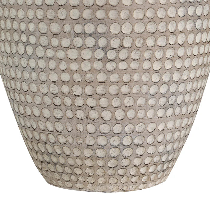 Close-up of a textured resin table lamp botton on the white background