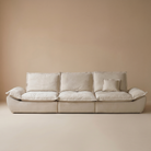 Full front view of the beige sailing-shaped modular sofa against a neutral background.