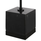 Black cube-shaped lamp base on a white background